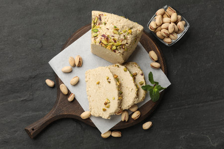 Tasty halva with pistachios and mint on gray table, top viewの写真素材