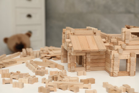 Wooden construction set on white table indoors, space for text. Children's toysの写真素材