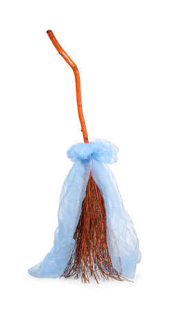 One beautiful witch's broom with tulle isolated on whiteの写真素材