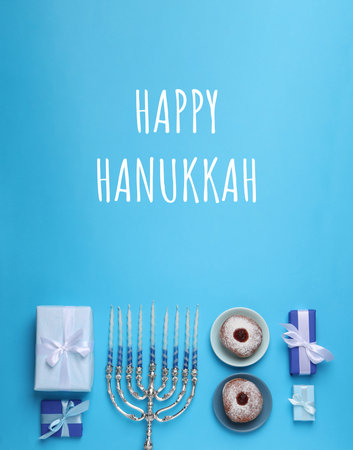 Happy Hanukkah. Menorah, candles, donuts and gifts on light blue background, flat layの写真素材