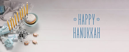 Happy Hanukkah. Menorah, donut, dreidels and gifts on white wooden table, banner designの写真素材
