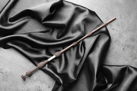 Magic wand and dark cloth on light gray background, top viewの写真素材