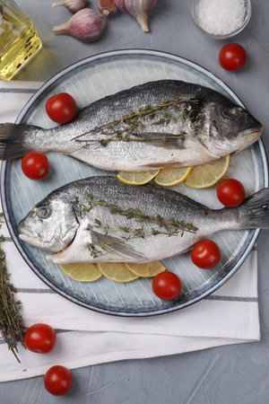 Flat lay composition with raw dorado fish on gray tableの写真素材