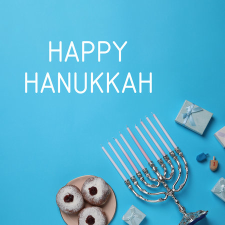 Happy Hanukkah. Menorah, donuts, dreidels and gifts on light blue background, flat layの写真素材