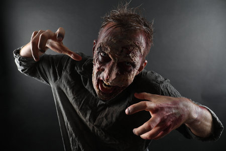 Scary zombie on dark background. Halloween monsterの写真素材