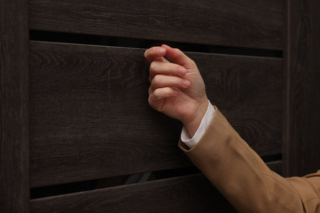 Collector knocking on door indoors, closeup viewの写真素材