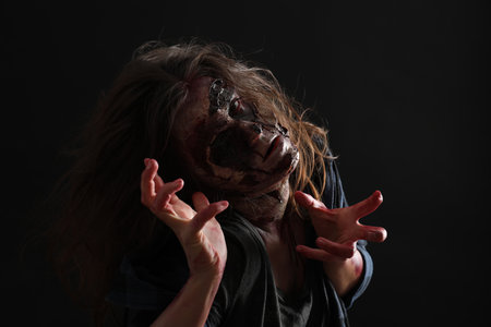Scary zombie on dark background. Halloween monsterの写真素材