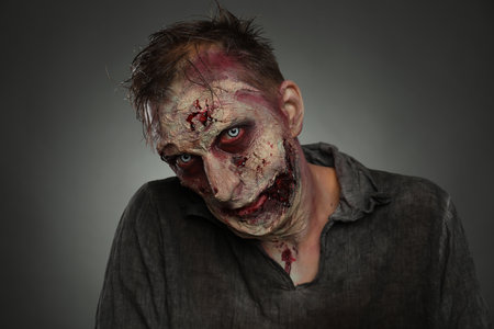Scary zombie on dark background. Halloween monsterの写真素材