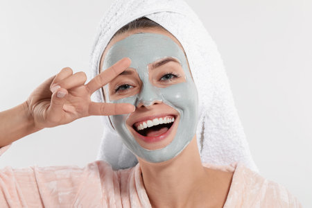 Woman with face mask on white background. Spa treatmentsの写真素材