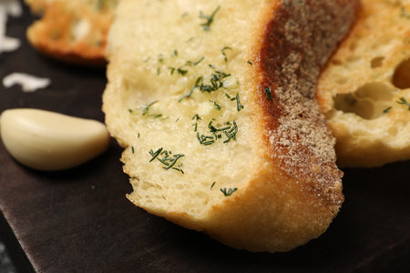 Tasty baguette with garlic and dill on table, closeupの写真素材