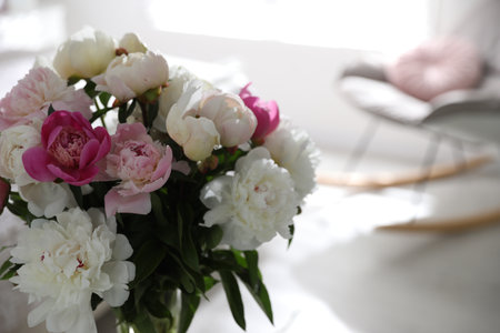 Beautiful blooming peonies against blurred background, closeup. Space for textの写真素材
