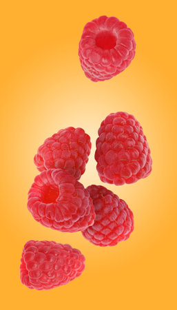 Fresh ripe raspberries falling on orange background