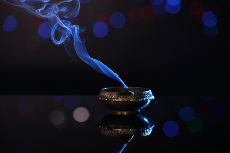 Blown out diya on dark background with blurred lights. Diwali lampの写真素材