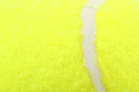 One tennis ball as background, closeup view