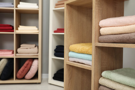 Different colorful bed linens and towels on display in home textiles store, closeupの写真素材