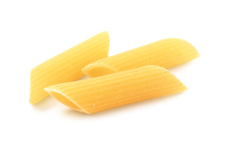 Raw penne pasta isolated on white. Italian cuisineの写真素材