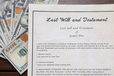 Last Will and Testament with dollar bills on wooden table, top viewの写真素材