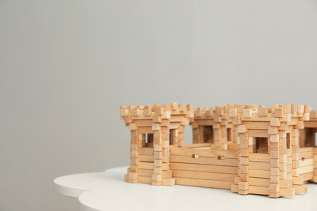 Wooden fortress on white table, space for text. Children's toysの写真素材