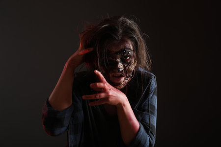 Scary zombie on dark background. Halloween monster