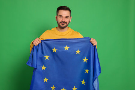 Man with flag of European Union on green backgroundの写真素材