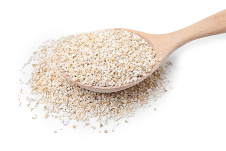 Spoon with raw barley groats isolated on whiteの写真素材