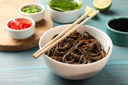 Tasty buckwheat noodles (soba) served on light blue wooden tableの写真素材