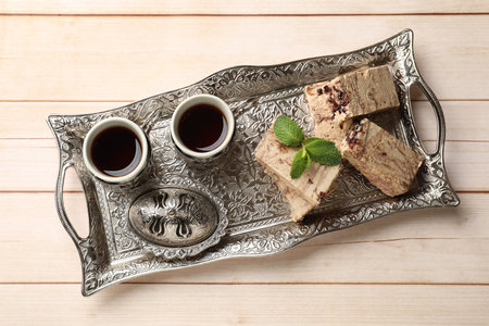 Tasty chocolate halva served on wooden table, top view