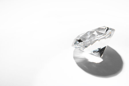One beautiful shiny diamond on white background, space for textの写真素材