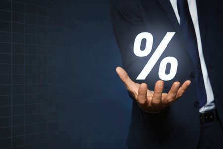 Mortgage. Man holding percent sign on dark blue background, closeup. Space for textの写真素材