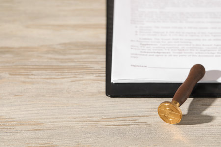 Notary contract. Wax stamp and documents on wooden table, space for textの写真素材