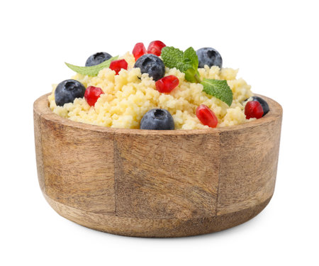 Bowl of tasty couscous with blueberries, pomegranate and mint isolated on whiteの写真素材
