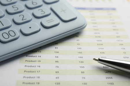 Calculator and pen on accounting document with data, closeup