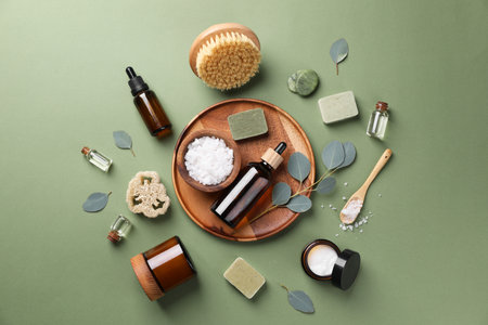 Flat lay composition with different spa products and eucalyptus branches on olive backgroundの写真素材