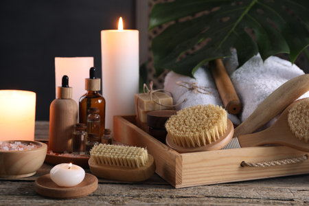 Composition with different spa products and burning candles on wooden tableの写真素材