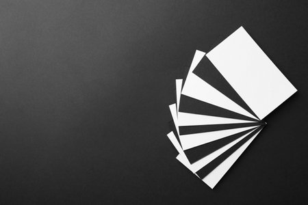 Blank business cards on black background, top view. Mockup for designの写真素材