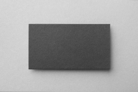 Blank black business card on light background, top view. Mockup for design