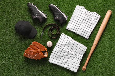 Flat lay composition with baseball equipment on artificial grass