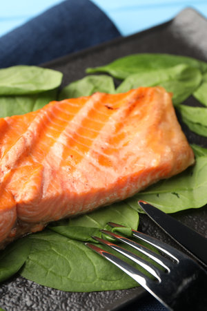 Tasty grilled salmon with spinach served on table, closeupの写真素材