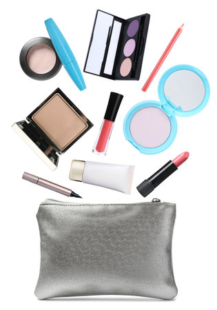 Cosmetic bag and falling makeup products into it on white backgroundの写真素材