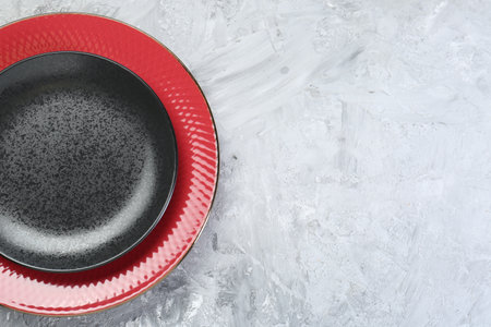 Clean plates on gray table, top view. Space for textの写真素材