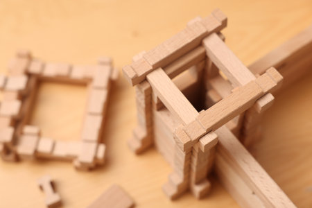 Wooden fortress and building blocks on table, closeup. Children's toysの写真素材