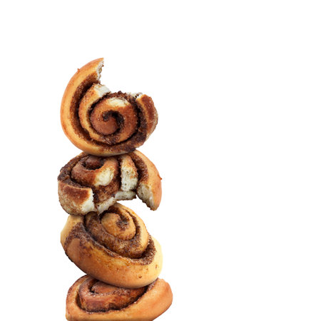 Fresh cinnamon rolls balancing on white backgroundの写真素材