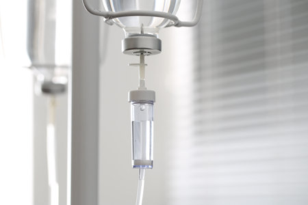 IV drip chamber against blurred light backgroundの写真素材