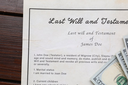 Last Will and Testament with dollar bills on wooden table, top viewの写真素材