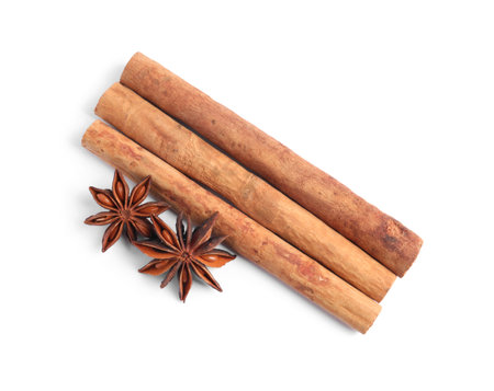 Aromatic cinnamon sticks and anise stars isolated on white, top viewの写真素材