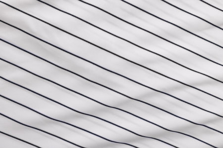 Striped baseball uniform as background, top view