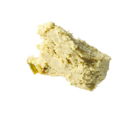 Piece of tasty pistachio halva isolated on whiteの写真素材