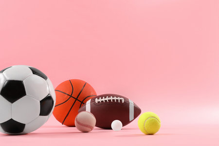 Many different sports balls on pink background, space for textの写真素材