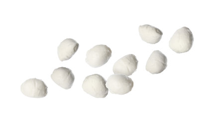 Fresh mozzarella balls falling on white backgroundの写真素材