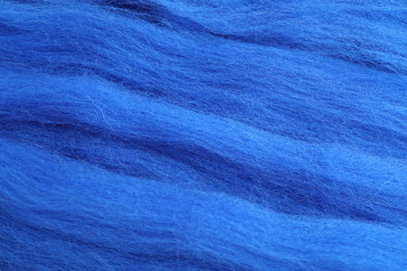 Blue felting wool as background, closeup view